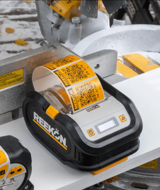 REEKON P1L label printer printing QR labels on a jobsite workbench